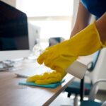 Person cleaning a desk