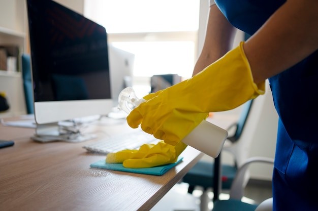 Person cleaning a desk